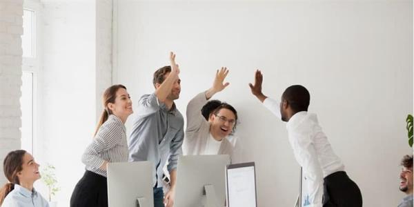 Group of business people giving a high-five.