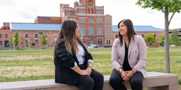 Two women talking outside of the Tivoli Student Union.