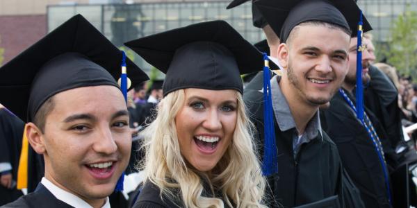 Students celebrate graduating with a major in Human Resources.