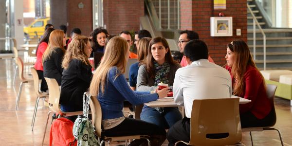 Students in the Major in Information Systems program engage in a case study discussion in a collaborative workspace.